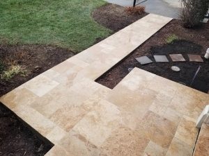What do you put in between travertine pavers to lock them in
